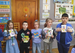 Dzieci pokazują pomalowane obrazki na temat autyzmu